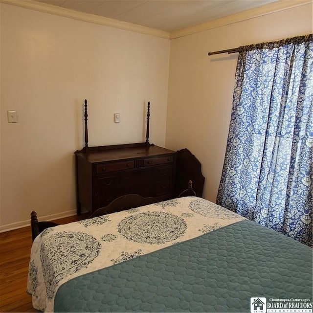 bedroom featuring crown molding and hardwood / wood-style flooring