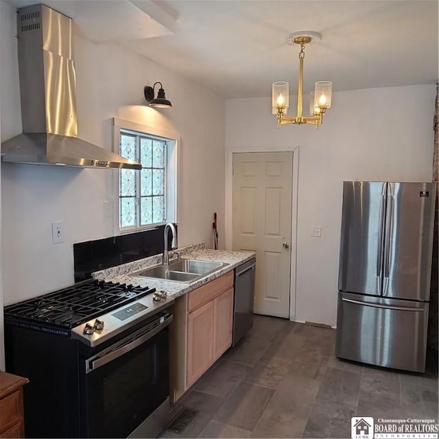 kitchen featuring decorative light fixtures, sink, an inviting chandelier, stainless steel appliances, and wall chimney exhaust hood