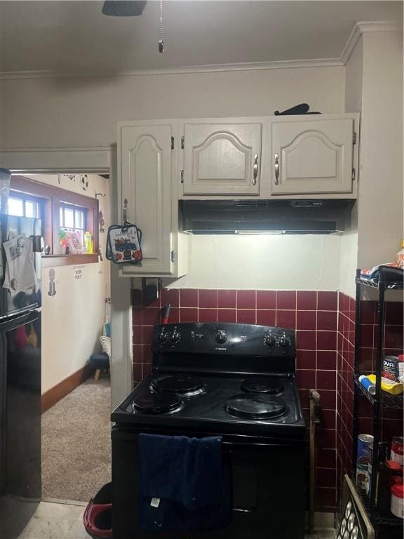 kitchen featuring white cabinets, black appliances, and crown molding