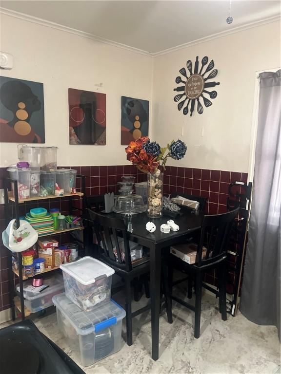 dining space featuring crown molding