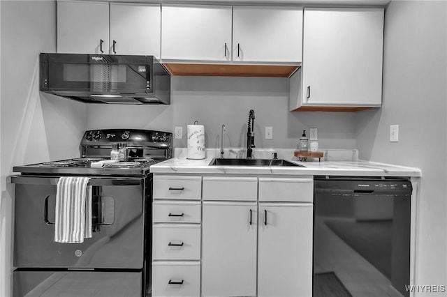 kitchen featuring sink, white cabinetry, and black appliances