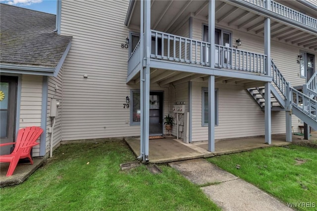 view of side of home featuring a patio area and a yard