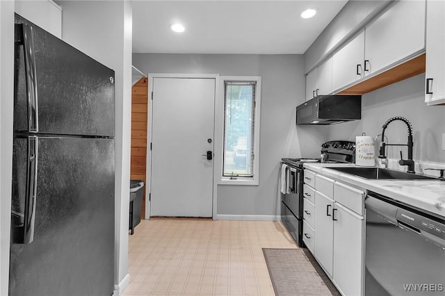 kitchen featuring black appliances, light stone countertops, sink, and white cabinetry