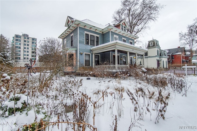 view of snow covered rear of property