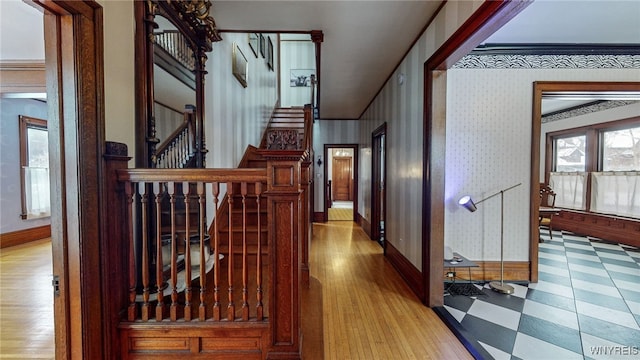 corridor featuring crown molding and light hardwood / wood-style flooring