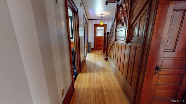 corridor with crown molding and light hardwood / wood-style flooring