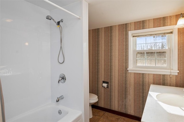 full bathroom featuring tile patterned floors, toilet, vanity, and  shower combination