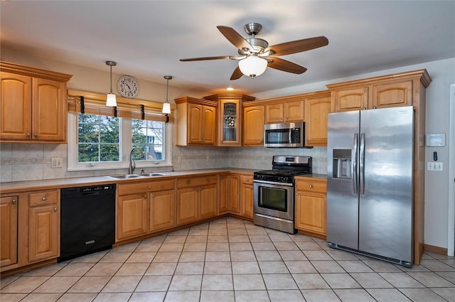 kitchen featuring ceiling fan, pendant lighting, sink, light tile patterned flooring, and appliances with stainless steel finishes