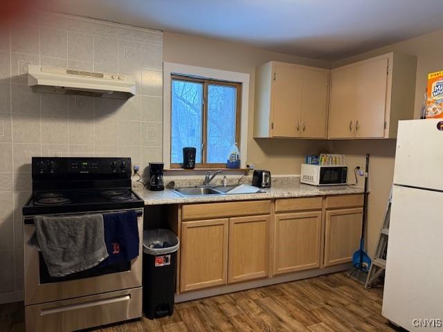 kitchen with sink, white appliances, and light hardwood / wood-style flooring