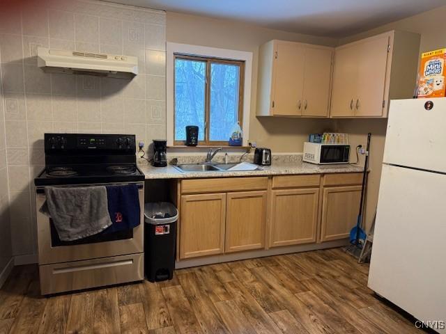 kitchen with sink, wood-type flooring, and white appliances