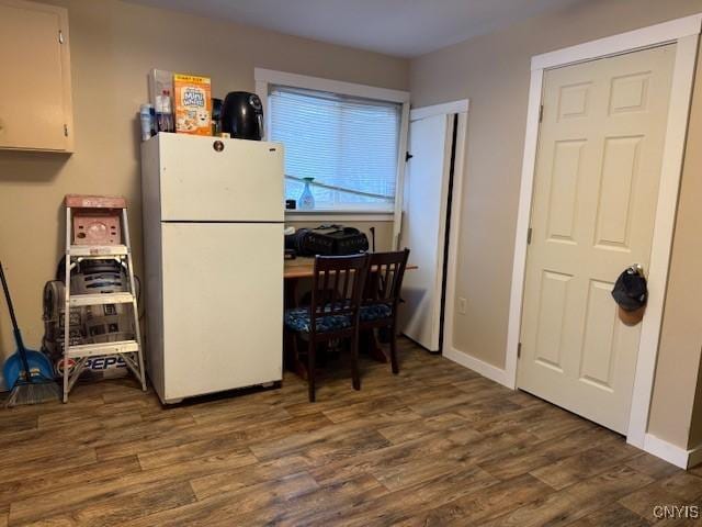 kitchen featuring white fridge, dark hardwood / wood-style flooring, and white cabinets