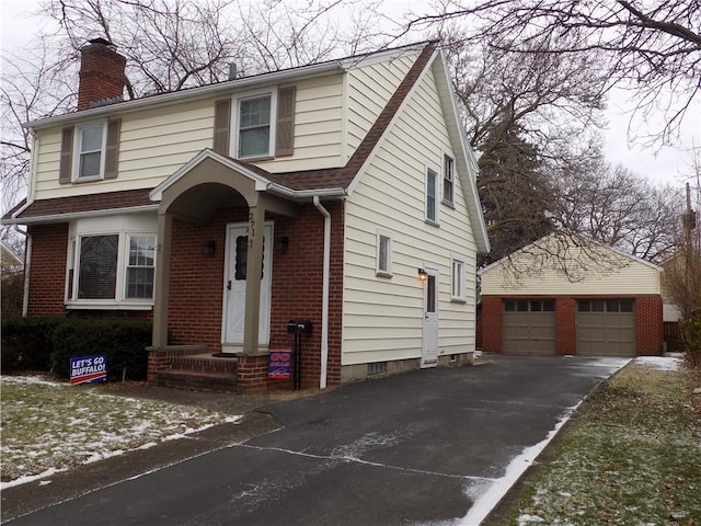 view of front of property with a garage and an outbuilding