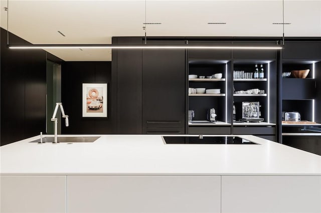 bar featuring sink and black electric stovetop