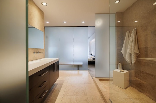 bathroom featuring a shower, tile patterned floors, and vanity