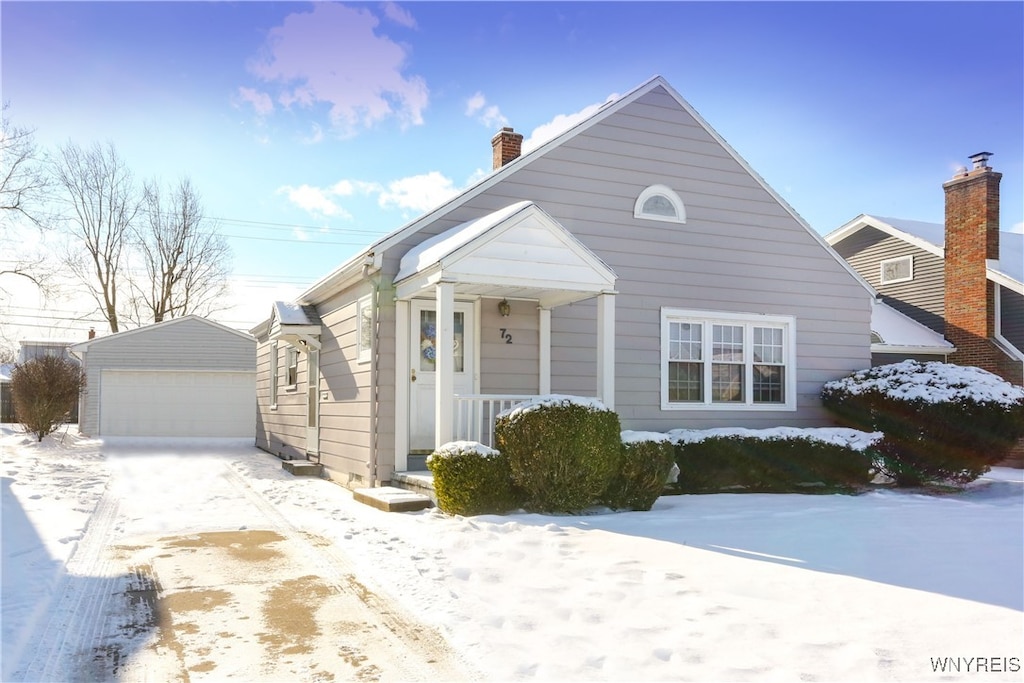 bungalow-style house with a garage and an outbuilding