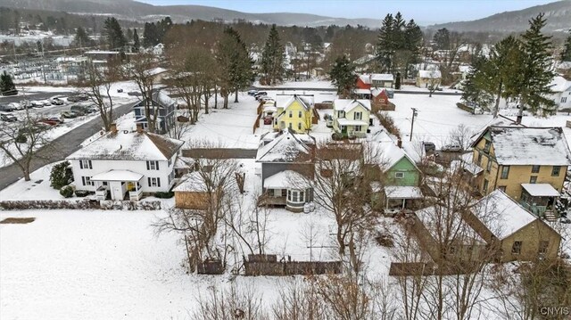 snowy aerial view featuring a mountain view