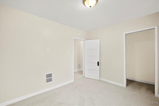 unfurnished bedroom featuring light carpet