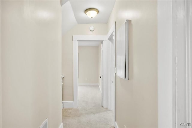 hall featuring light colored carpet