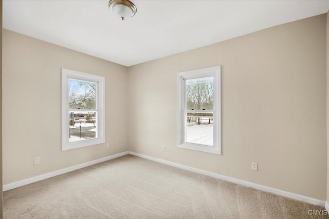 carpeted empty room with a wealth of natural light