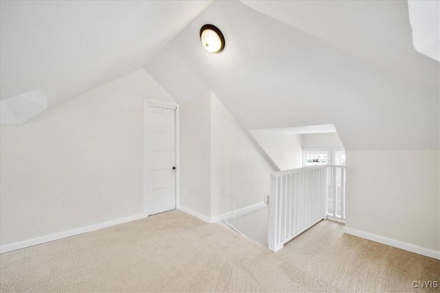 bonus room featuring light carpet and lofted ceiling