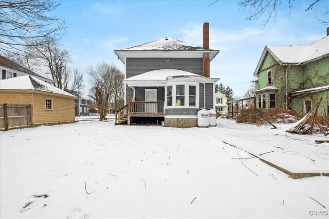 snow covered property featuring a deck