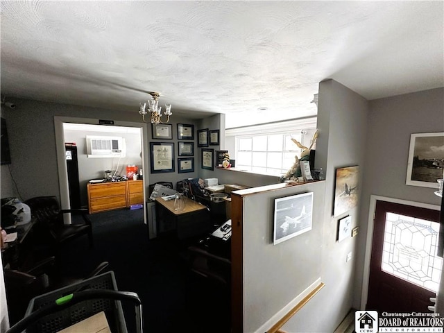 kitchen with a chandelier, a wall unit AC, and carpet floors