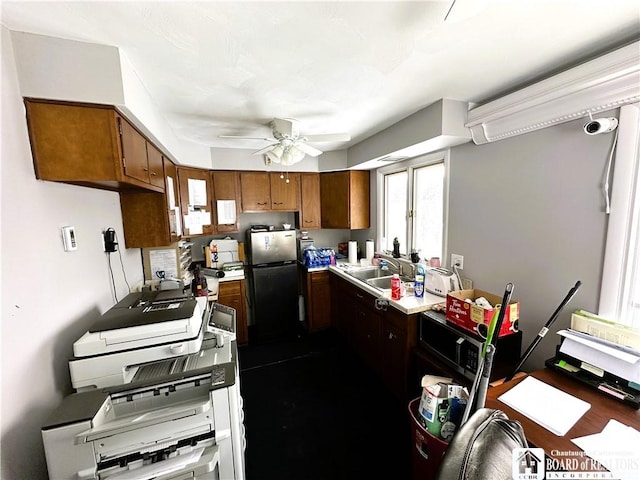 kitchen featuring sink, ceiling fan, and stainless steel refrigerator