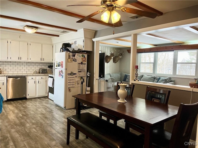 dining room with ceiling fan, beamed ceiling, and light hardwood / wood-style floors