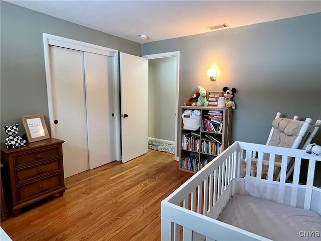 bedroom with a closet and light wood-type flooring