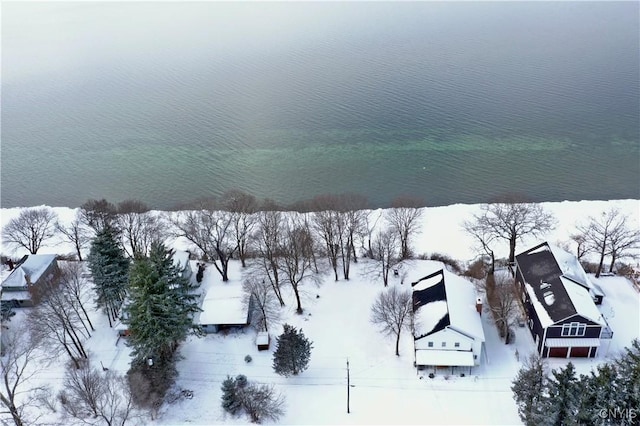 snowy aerial view featuring a water view