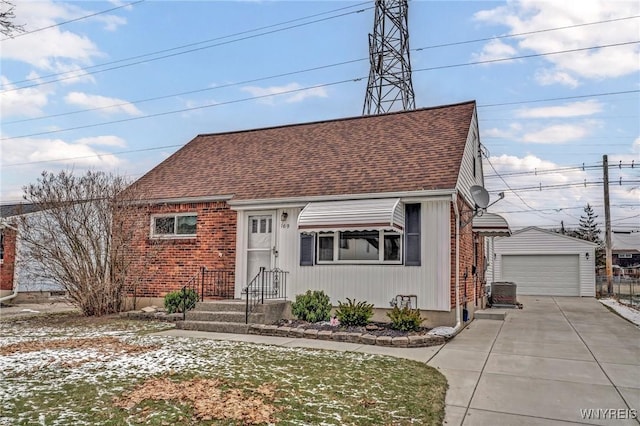 view of front of home featuring a garage, central air condition unit, and an outdoor structure