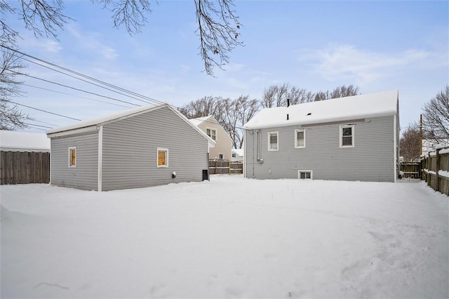 view of snow covered back of property