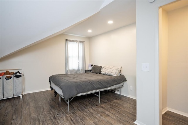 bedroom with vaulted ceiling and dark wood-type flooring