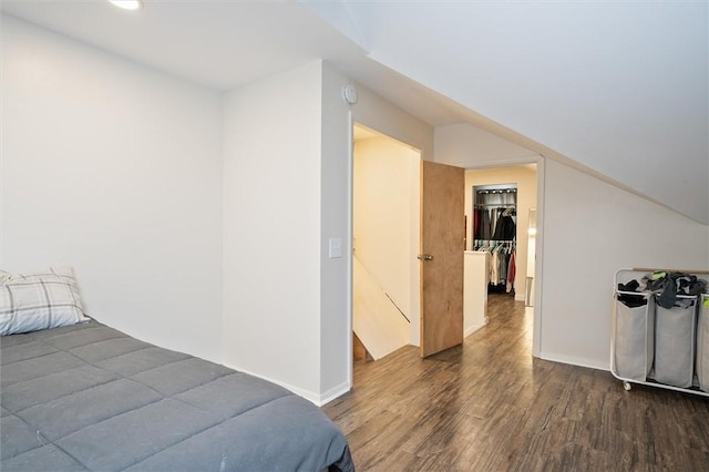 bedroom featuring dark hardwood / wood-style floors, a closet, and vaulted ceiling