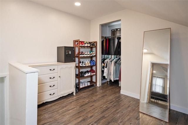 walk in closet featuring dark hardwood / wood-style flooring and lofted ceiling