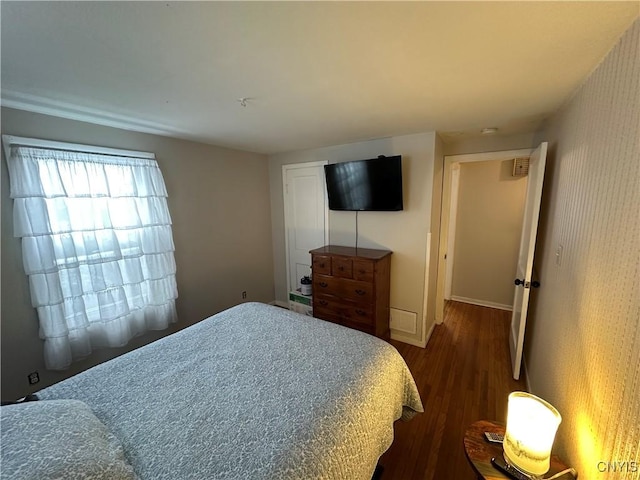 bedroom with dark wood-type flooring