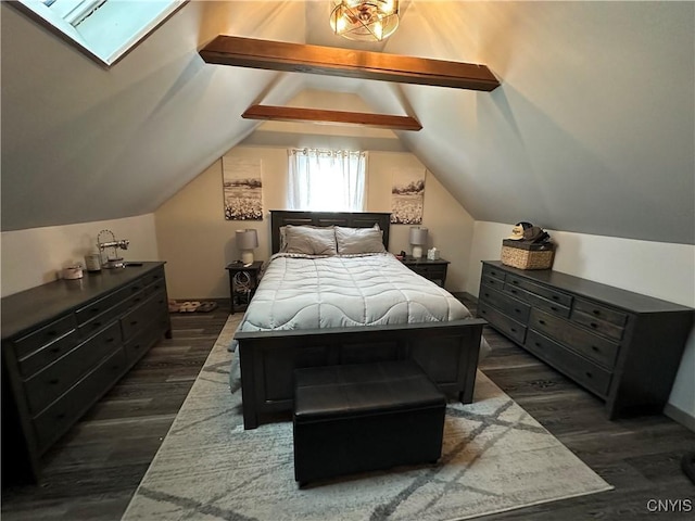 bedroom featuring lofted ceiling with skylight and dark hardwood / wood-style flooring