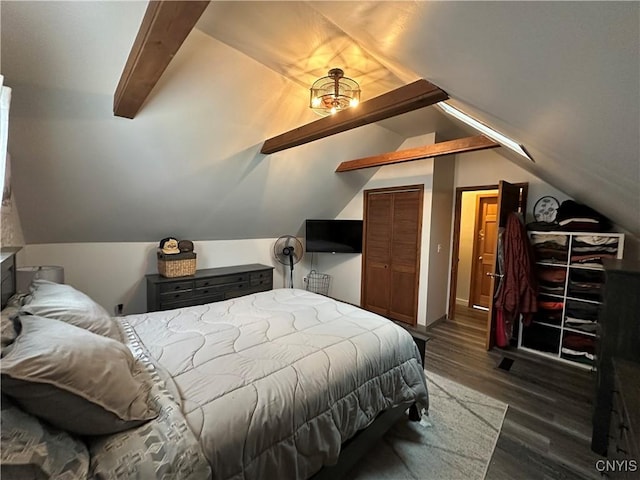 bedroom featuring a closet, dark hardwood / wood-style floors, and vaulted ceiling with beams