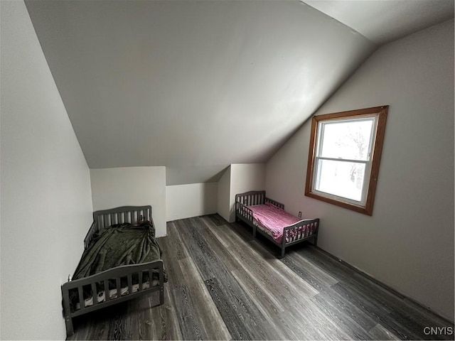 bedroom with hardwood / wood-style floors and vaulted ceiling