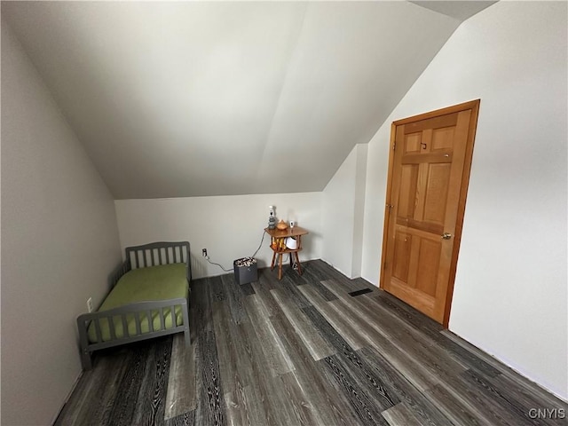 bonus room with dark hardwood / wood-style floors and lofted ceiling