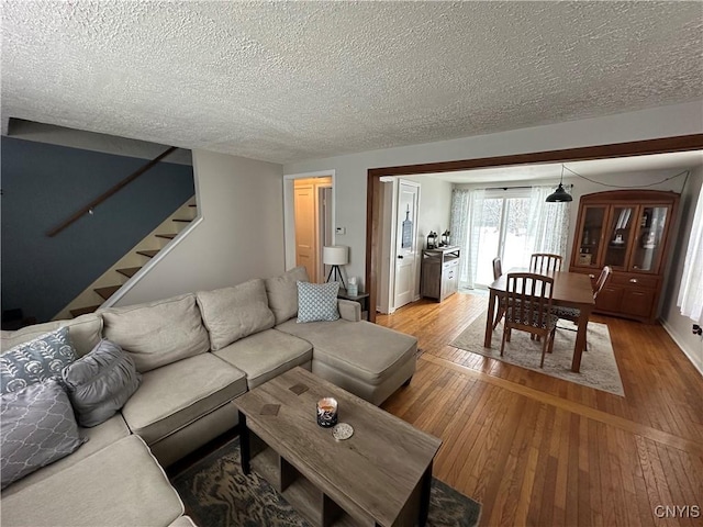 living room featuring a textured ceiling and hardwood / wood-style flooring