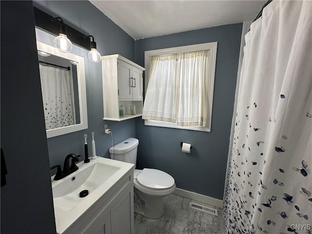 bathroom with walk in shower, vanity, and toilet