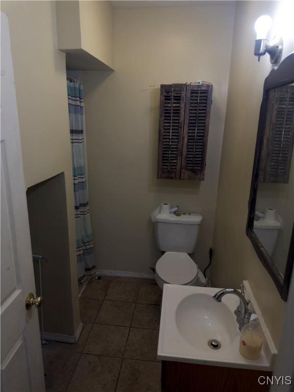 bathroom with sink, toilet, walk in shower, and tile patterned floors