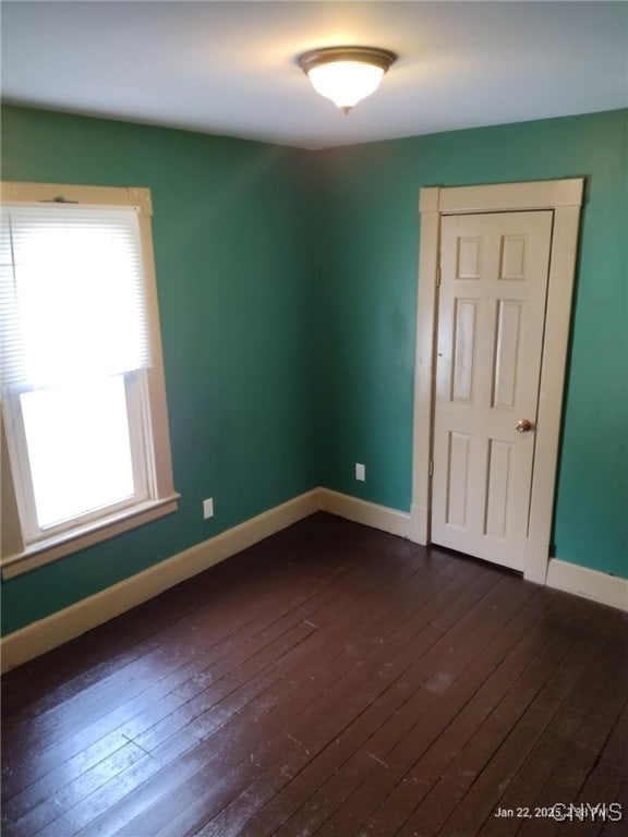 empty room with dark wood-type flooring