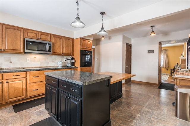 kitchen featuring black oven, pendant lighting, tasteful backsplash, and a kitchen island