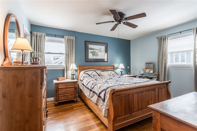 bedroom with ceiling fan and light hardwood / wood-style flooring