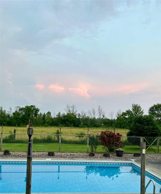 view of pool at dusk