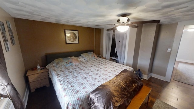 bedroom featuring ceiling fan and dark hardwood / wood-style floors