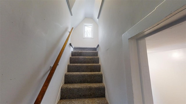 stairway with vaulted ceiling