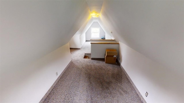 bonus room featuring vaulted ceiling and carpet flooring